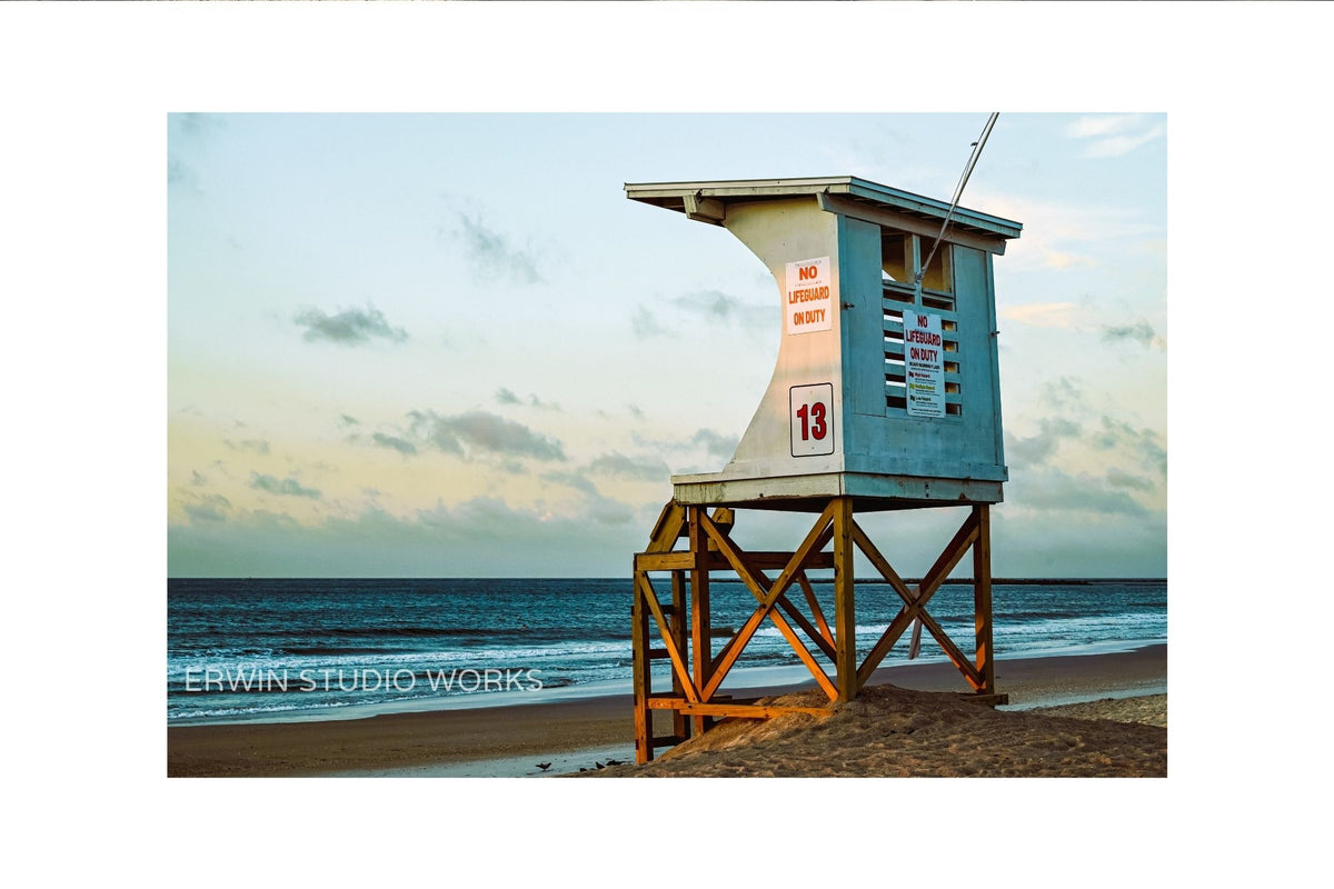 Lifeguard tower on a beach with ocean and sky in the background in Wrightsville Beach North Carolina