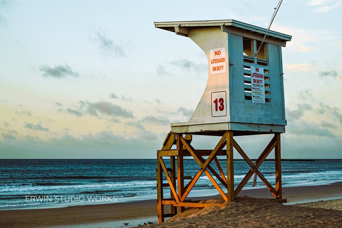 Lifeguard tower on a beach with ocean and sky in the background in Wrightsville Beach North Carolina